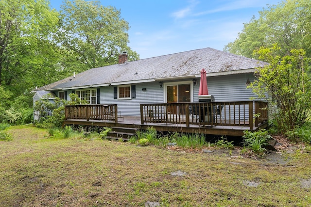 18 Ginger Ln, Saco, ME 04072 - back of house featuring a chimney, a wooden deck, and a lawn