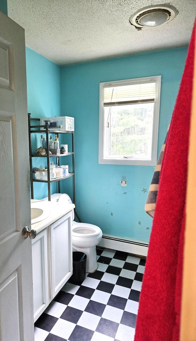 25 Mill Ln, Naples, ME 04055 - half bath featuring tile patterned floors, a baseboard heating unit, toilet, vanity, and a textured ceiling