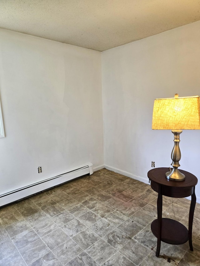 25 Mill Ln, Naples, ME 04055 - unfurnished room with baseboard heating, baseboards, and stone finish floors