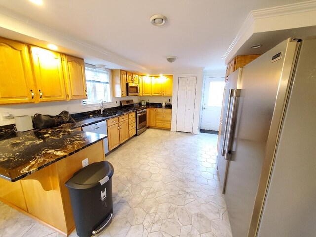 259-265 Bowden Point Rd, Prospect, ME 04981 - kitchen featuring appliances with stainless steel finishes, a peninsula, dark stone countertops, ornamental molding, and a sink