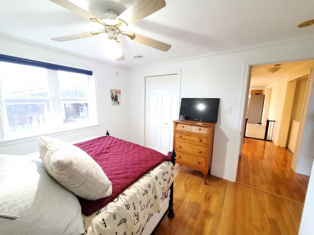 259-265 Bowden Point Rd, Prospect, ME 04981 - bedroom with light wood-style flooring, ceiling fan, a closet, ornamental molding, and baseboards