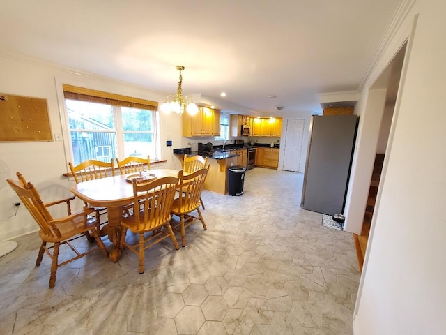 259-265 Bowden Point Rd, Prospect, ME 04981 - dining space featuring a chandelier, crown molding, and light stone finish flooring
