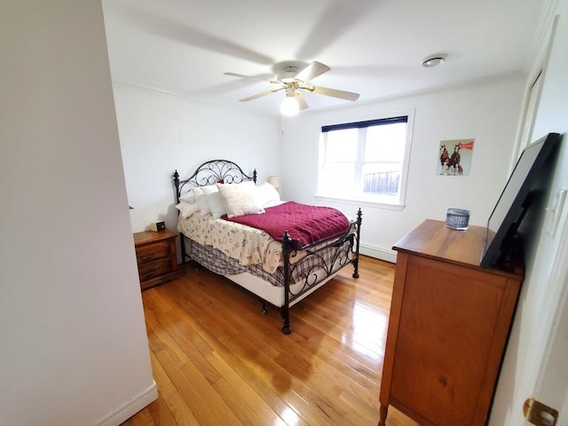 259-265 Bowden Point Rd, Prospect, ME 04981 - bedroom featuring light wood-style floors, a baseboard heating unit, and ceiling fan