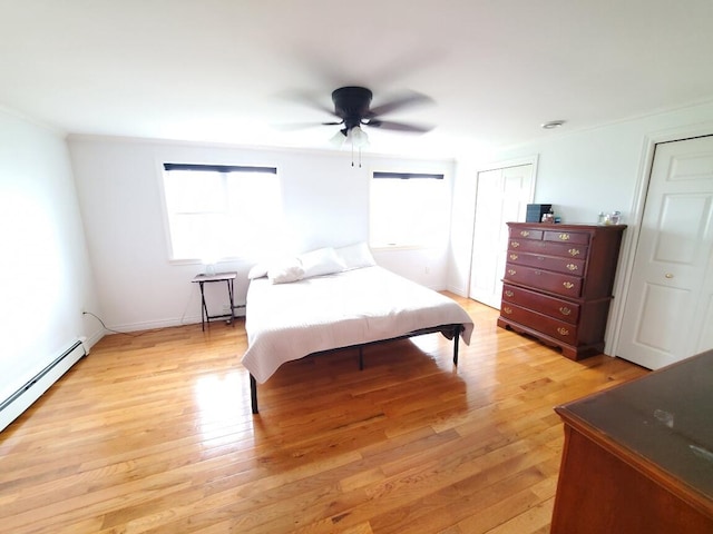 259-265 Bowden Point Rd, Prospect, ME 04981 - bedroom with a baseboard heating unit, light wood-style flooring, ornamental molding, and ceiling fan