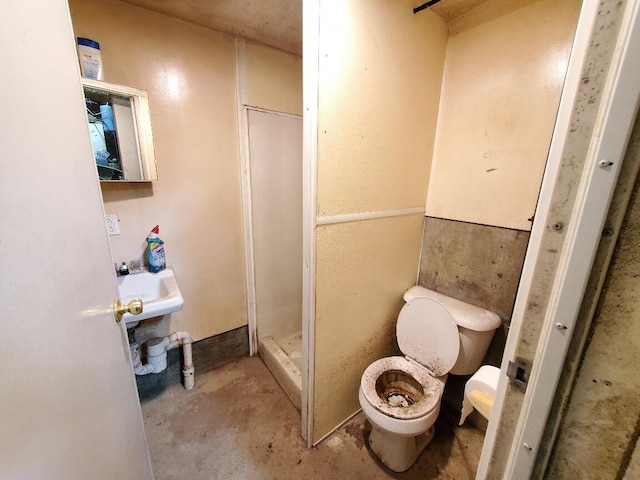 259-265 Bowden Point Rd, Prospect, ME 04981 - full bath featuring toilet, concrete floors, a shower stall, and a sink