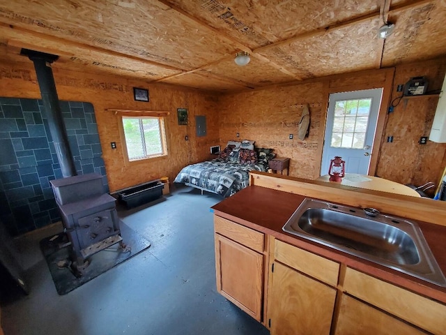 259-265 Bowden Point Rd, Prospect, ME 04981 - bedroom featuring a wood stove, finished concrete flooring, and a sink