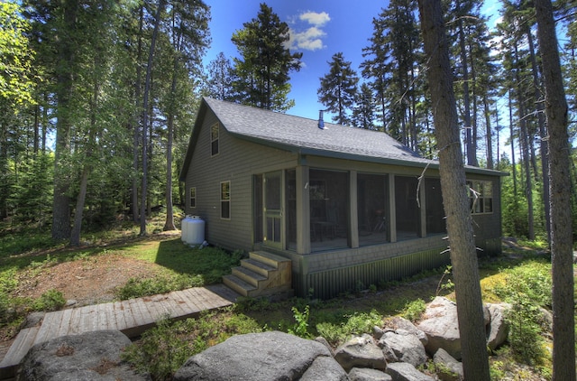 113 W Arm Rd, Magalloway Plt, ME 04970 - view of property exterior featuring a sunroom and roof with shingles