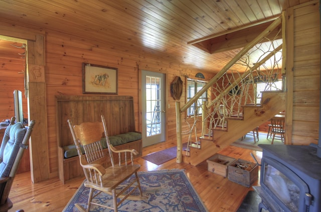 113 W Arm Rd, Magalloway Plt, ME 04970 - entrance foyer featuring stairs, wood ceiling, wood walls, a wood stove, and hardwood / wood-style flooring