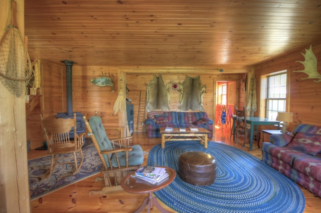 113 W Arm Rd, Magalloway Plt, ME 04970 - living area featuring a wood stove, wooden ceiling, wood finished floors, and wooden walls