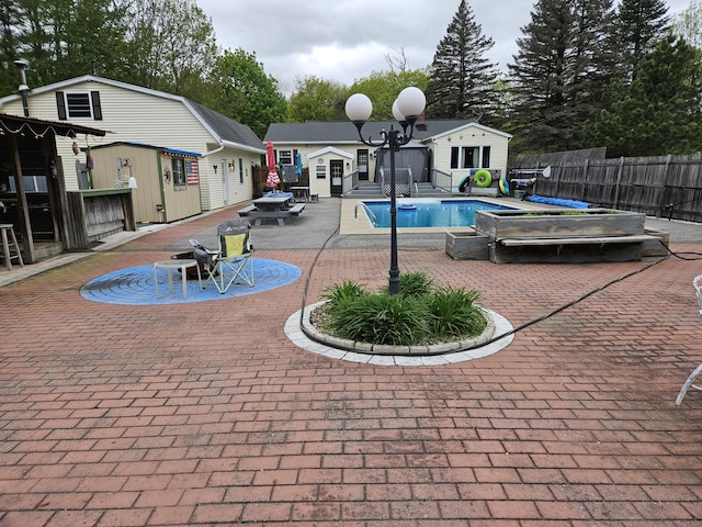view of pool with an exterior structure, an outdoor structure, and a patio