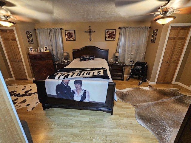 bedroom featuring wood finished floors, baseboards, and ceiling fan