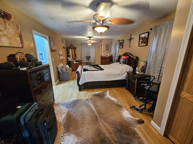 bedroom featuring wood finished floors and ceiling fan