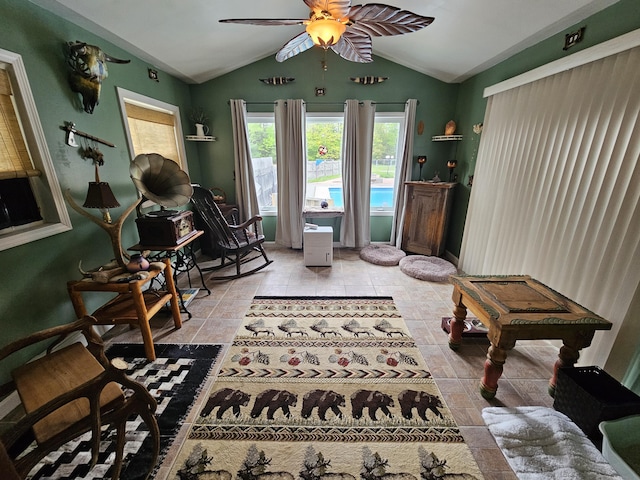 living area with vaulted ceiling and a ceiling fan