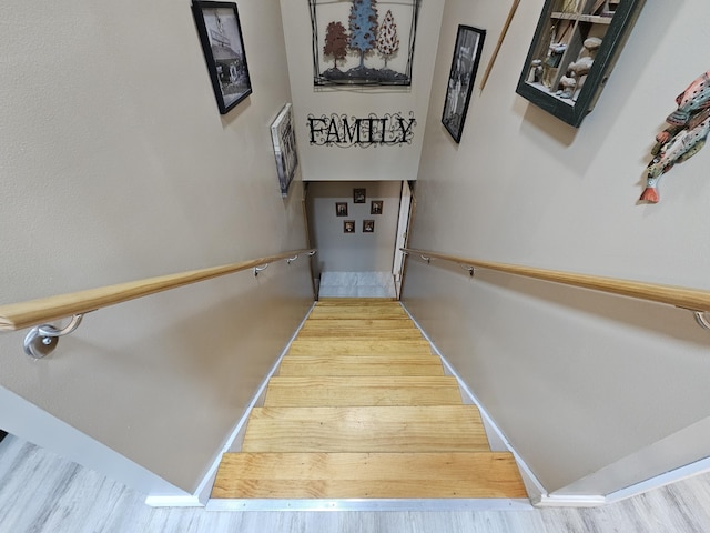 staircase with wood finished floors