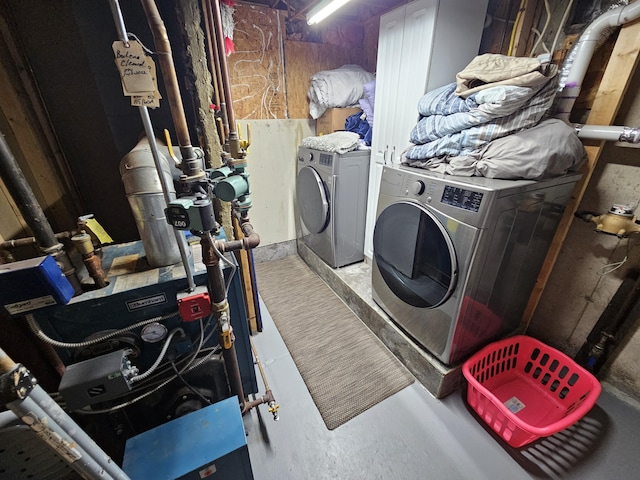 laundry room featuring separate washer and dryer and a heating unit