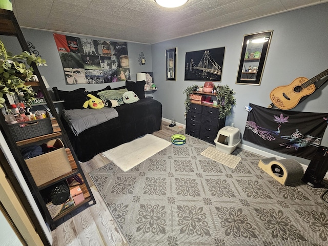 bedroom featuring baseboards and wood finished floors
