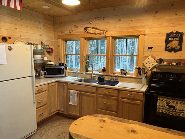 54 Orris Lamb Rd W, Dallas Plt, ME 04970 - kitchen with freestanding refrigerator, black electric range, stainless steel microwave, wood walls, and light countertops