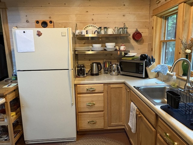 54 Orris Lamb Rd W, Dallas Plt, ME 04970 - kitchen featuring freestanding refrigerator, stainless steel microwave, wooden walls, and light countertops