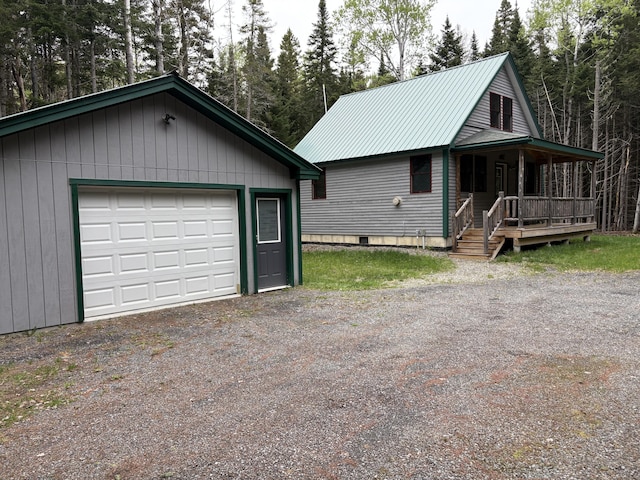54 Orris Lamb Rd W, Dallas Plt, ME 04970 - view of front of home with an outdoor structure, a garage, a porch, and metal roof