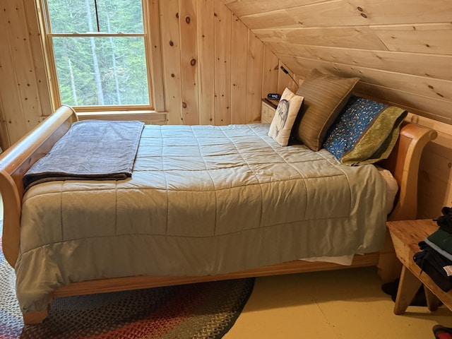 54 Orris Lamb Rd W, Dallas Plt, ME 04970 - bedroom with lofted ceiling and wood walls