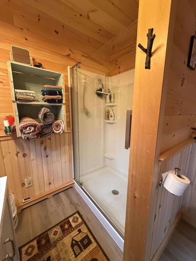 54 Orris Lamb Rd W, Dallas Plt, ME 04970 - full bath featuring a stall shower, wood finished floors, and wood walls