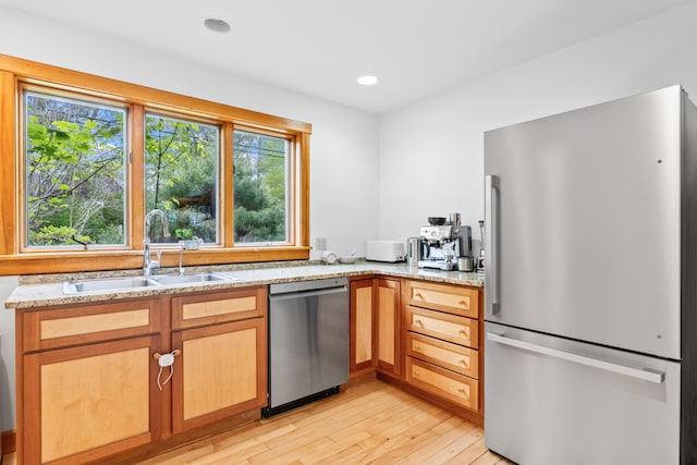 21 Harpswell Islands Rd, Harpswell, ME 04079 - kitchen featuring appliances with stainless steel finishes, a sink, light wood-style floors, light stone countertops, and recessed lighting