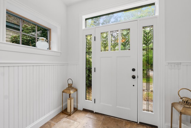 21 Harpswell Islands Rd, Harpswell, ME 04079 - foyer with stone tile flooring, a decorative wall, and wainscoting