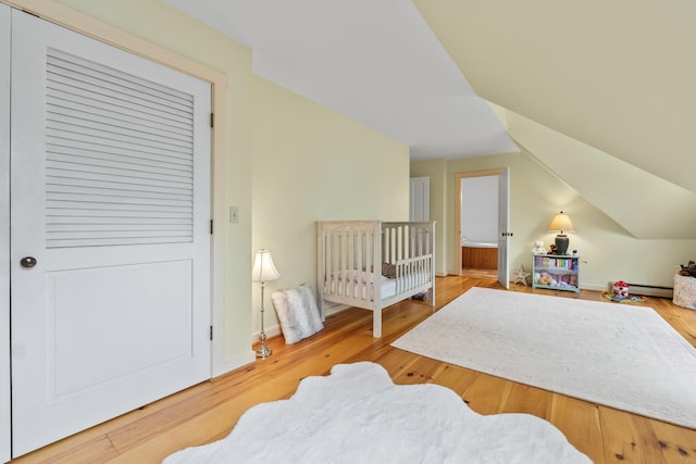 21 Harpswell Islands Rd, Harpswell, ME 04079 - bedroom featuring a baseboard heating unit, wood finished floors, and lofted ceiling