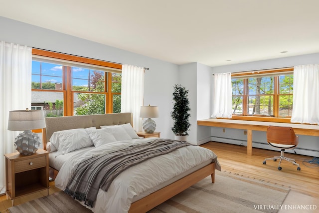 21 Harpswell Islands Rd, Harpswell, ME 04079 - bedroom with wood finished floors, a desk, and a baseboard radiator