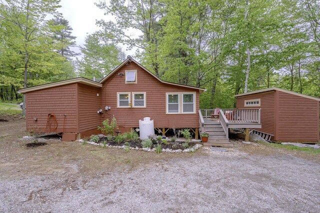 107 Meadow Rd, Raymond, ME 04071 - rear view of property with a wooden deck and view of wooded area