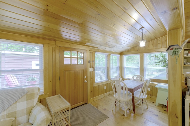 107 Meadow Rd, Raymond, ME 04071 - dining space with lofted ceiling, wooden ceiling, light wood-style floors, and wood walls