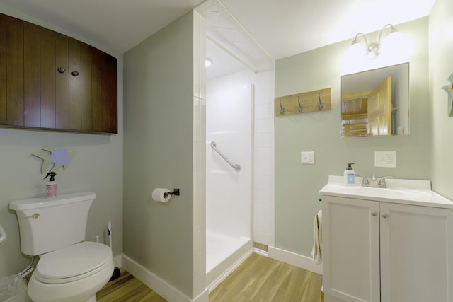 107 Meadow Rd, Raymond, ME 04071 - bathroom featuring toilet, wood finished floors, vanity, a tile shower, and baseboards