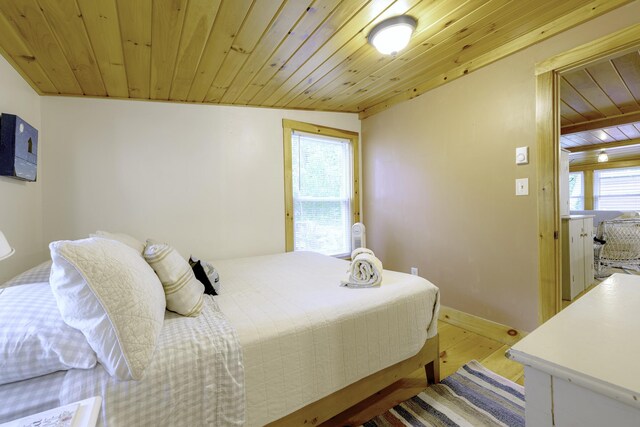 107 Meadow Rd, Raymond, ME 04071 - bedroom with light wood finished floors, wood ceiling, and baseboards