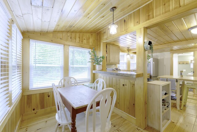 107 Meadow Rd, Raymond, ME 04071 - dining area featuring wood walls, wood ceiling, healthy amount of natural light, vaulted ceiling, and light wood-style floors