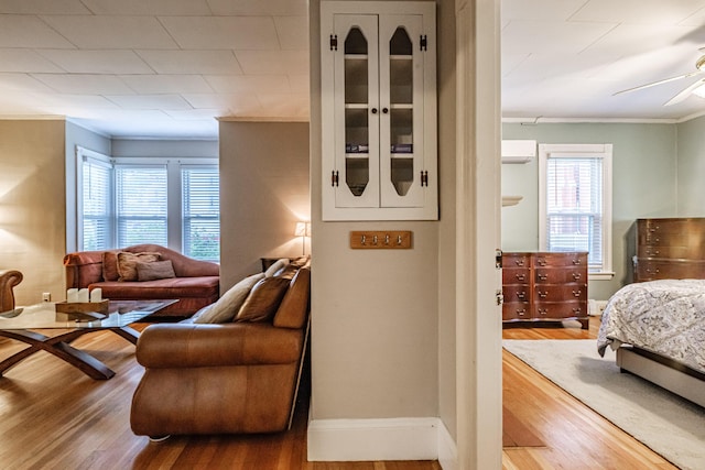 45 High St, Biddeford, ME 04005 - living area with ornamental molding, ceiling fan, wood finished floors, and plenty of natural light