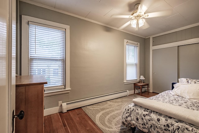45 High St, Biddeford, ME 04005 - bedroom featuring baseboard heating, baseboards, crown molding, wood finished floors, and multiple windows