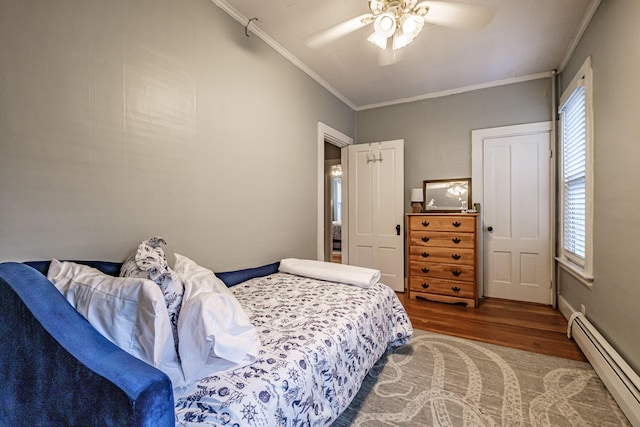 45 High St, Biddeford, ME 04005 - bedroom with a baseboard radiator, wood finished floors, ornamental molding, multiple windows, and ceiling fan