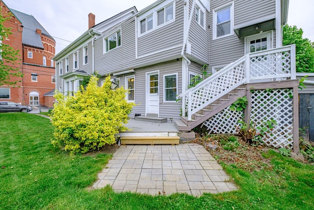 45 High St, Biddeford, ME 04005 - rear view of property featuring a lawn, a chimney, and a wooden deck