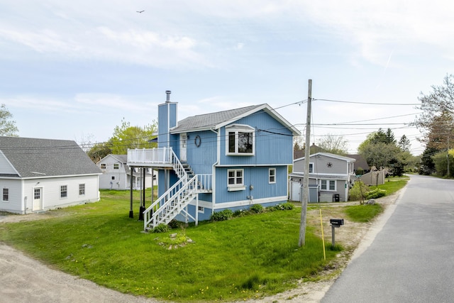 197 Ash Point Rd, Harpswell, ME 04079 - view of front facade with stairs, a chimney, a front lawn, and a deck