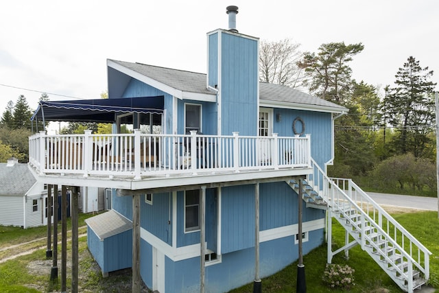 197 Ash Point Rd, Harpswell, ME 04079 - rear view of property featuring a wooden deck, stairs, a chimney, and a storage unit