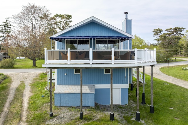 197 Ash Point Rd, Harpswell, ME 04079 - rear view of house featuring dirt driveway, a lawn, and a chimney