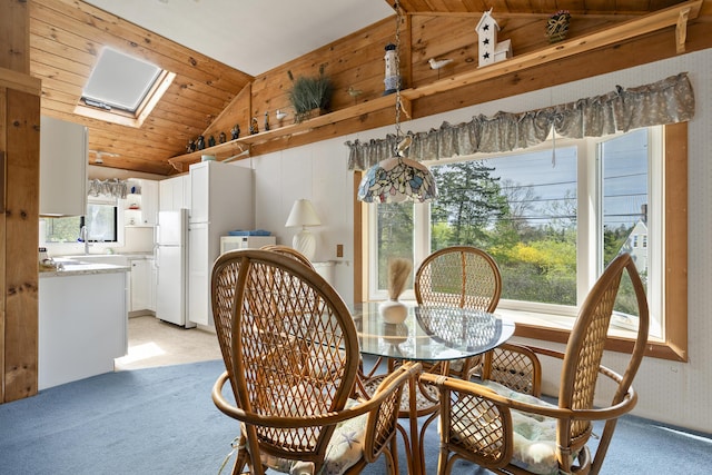 197 Ash Point Rd, Harpswell, ME 04079 - dining space featuring vaulted ceiling, light carpet, a skylight, and wood ceiling