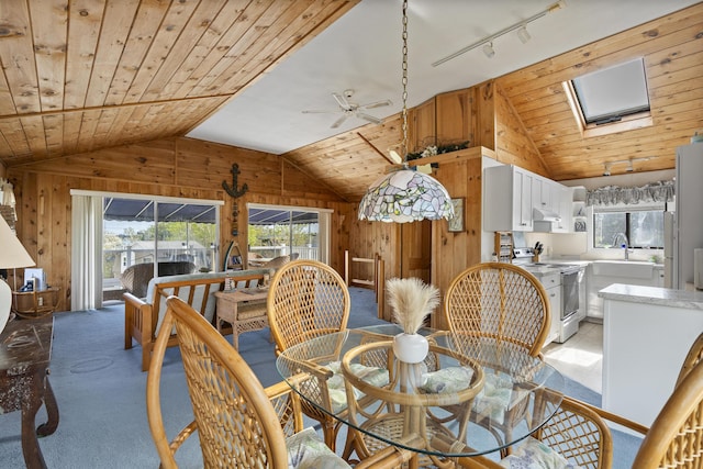 197 Ash Point Rd, Harpswell, ME 04079 - carpeted dining space featuring wooden walls, lofted ceiling, a ceiling fan, wooden ceiling, and a sink