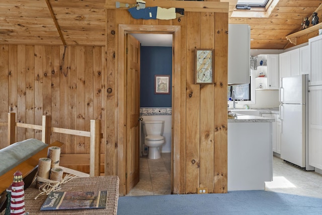 197 Ash Point Rd, Harpswell, ME 04079 - bathroom featuring wood ceiling, toilet, lofted ceiling, wood walls, and a skylight
