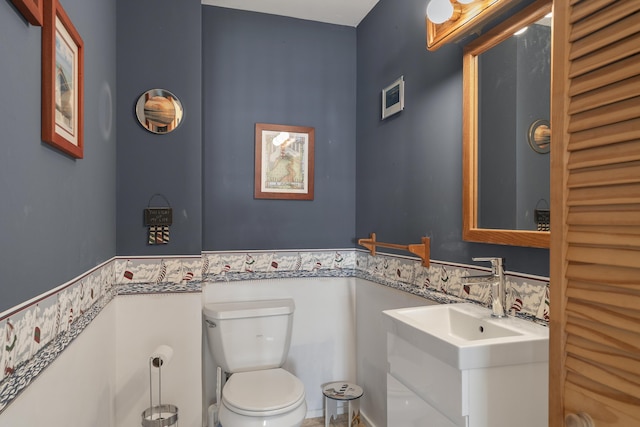 197 Ash Point Rd, Harpswell, ME 04079 - bathroom with toilet, wainscoting, and vanity