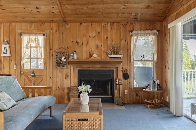 197 Ash Point Rd, Harpswell, ME 04079 - living room featuring wood ceiling, carpet, lofted ceiling, a fireplace with flush hearth, and wooden walls