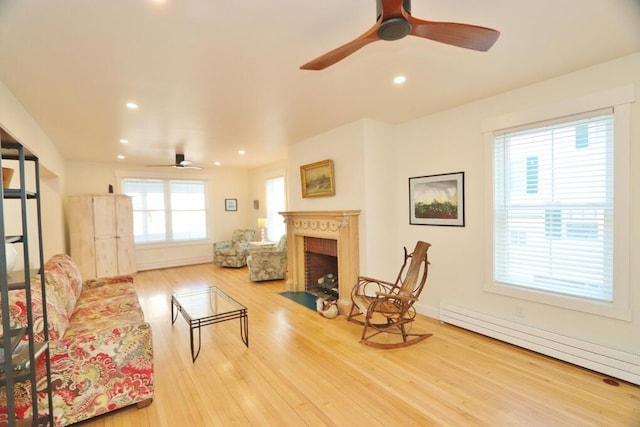 228 French St, Bangor, ME 04401 - living area with ceiling fan, baseboard heating, a fireplace with flush hearth, wood finished floors, and recessed lighting