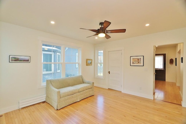 228 French St, Bangor, ME 04401 - living area with a baseboard radiator, light wood-style flooring, a ceiling fan, plenty of natural light, and recessed lighting