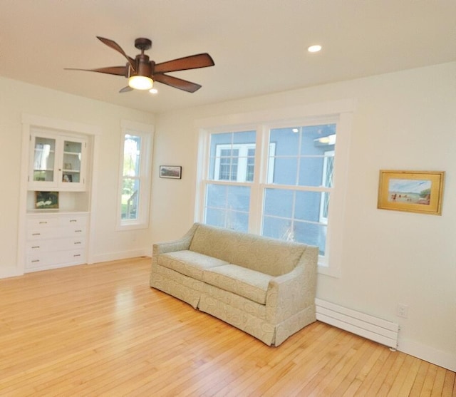 228 French St, Bangor, ME 04401 - sitting room with light wood finished floors, baseboard heating, ceiling fan, baseboards, and recessed lighting