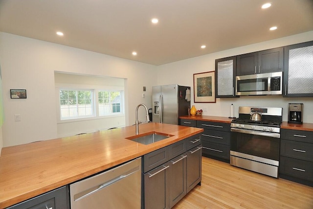 228 French St, Bangor, ME 04401 - kitchen with stainless steel appliances, butcher block counters, a sink, recessed lighting, and light wood-type flooring